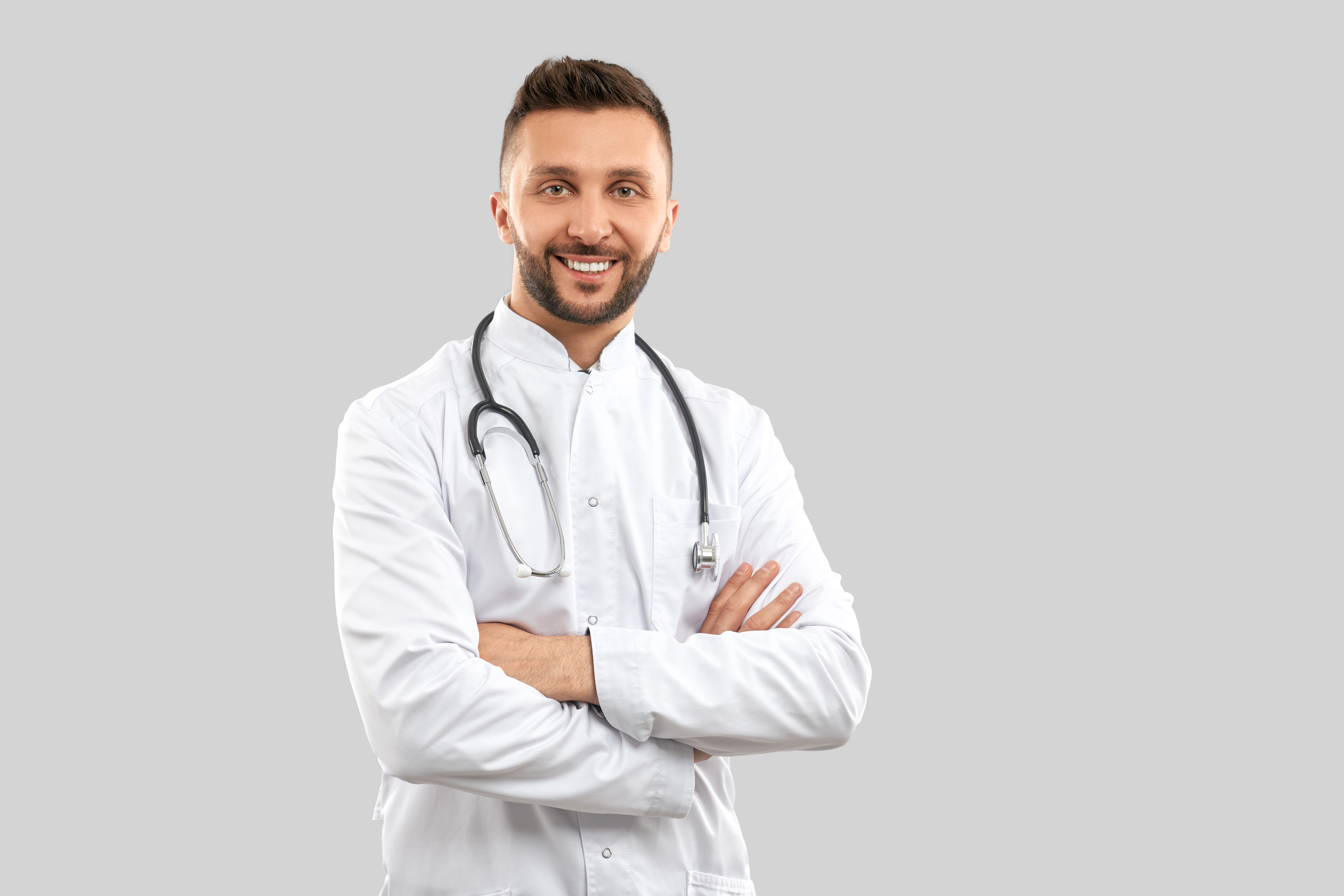 smiling-doctor-with-strethoscope-isolated-grey